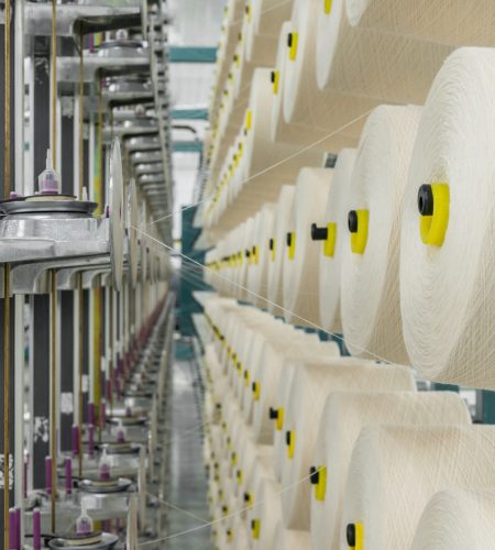 white textile yarn on the warping machine. machinery and equipment in a textile factory